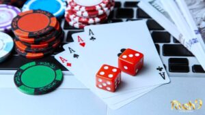 playing cards, casino chips ad 2 red dice above a keyboard